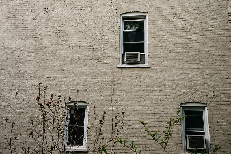 two-white-window-type-ac-s-on-glass-windows