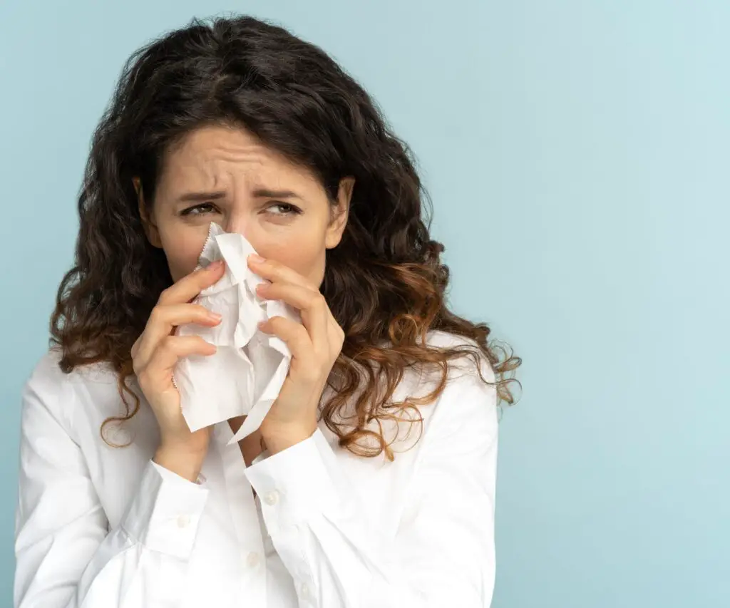 woman covering her nose because of skunk smell